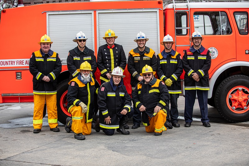 (Back row): Brett Eastwood, Peter Dedman, Tony Owen, David Maxwell, Daryl Owen and Paul Scragg. (Front row): Trevor Franklin, Stewart Kreltszheim and Eddie Tichelaar in front of a restored vehicle